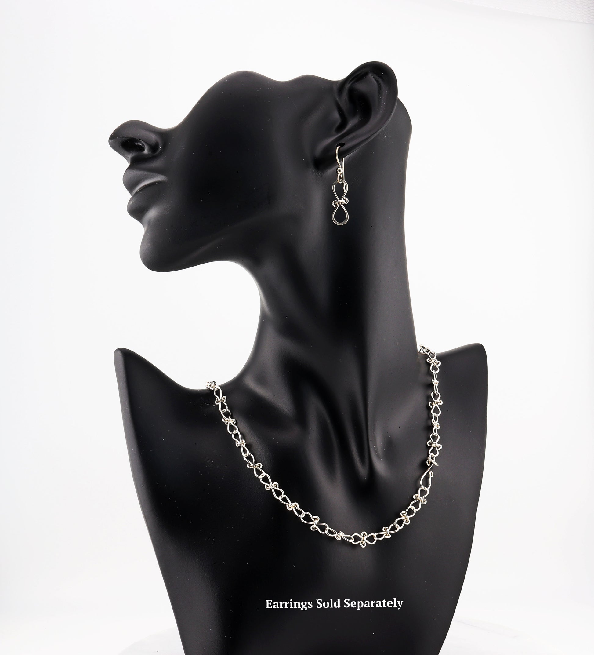 Handcrafted with care in our Missouri studio, this Infinity Bow Necklace by Elkhorn Silver™ is made from premium Argentium® 935 silver for a hypoallergenic, tarnish-resistant finish. Featuring intricate infinity bow shapes that symbolize eternal love and connection, this necklace is both meaningful and stylish. Available with matching optional earrings.