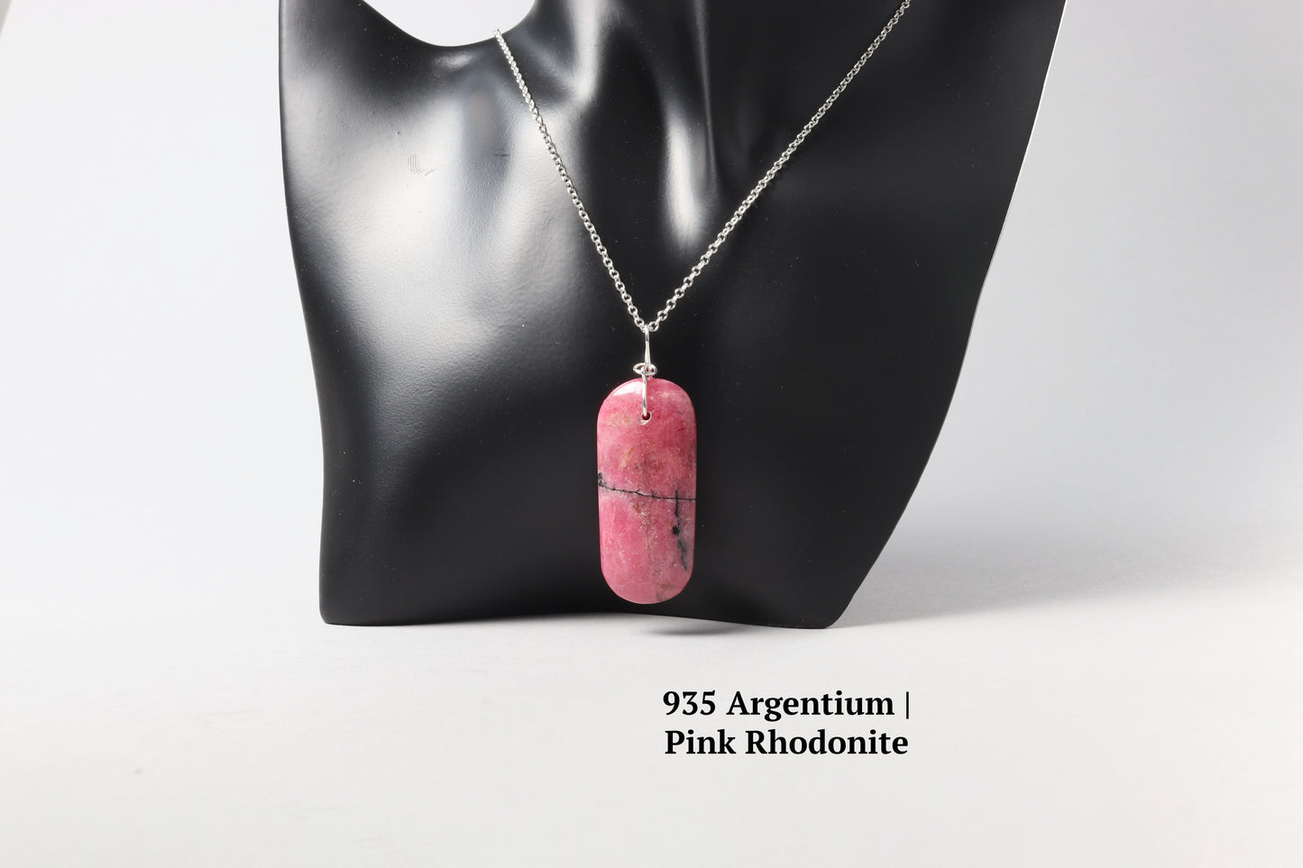 A Pink Rhodonite with 18" solid Argentium® 935 chain shown on black resin jewelry mannequin.