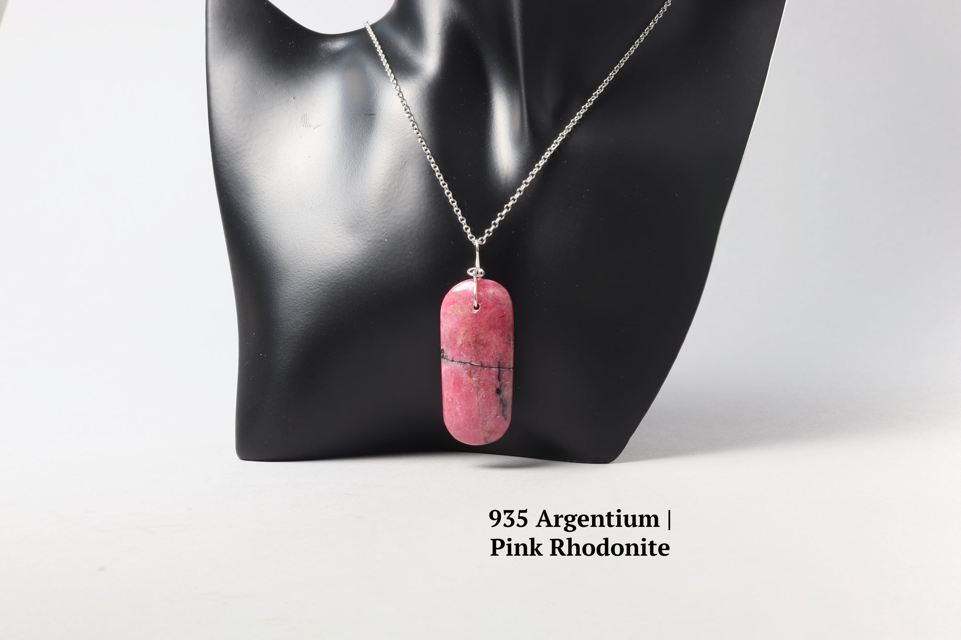 A Pink Rhodonite with 18" solid Argentium® 935 chain shown on black resin jewelry mannequin.