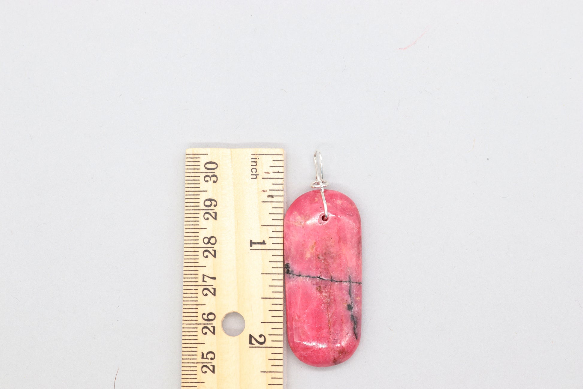 2.26 inch Pink Rhodonite Pendant with Argentium 935 custom wire bail shown next to ruler for measurement verification.