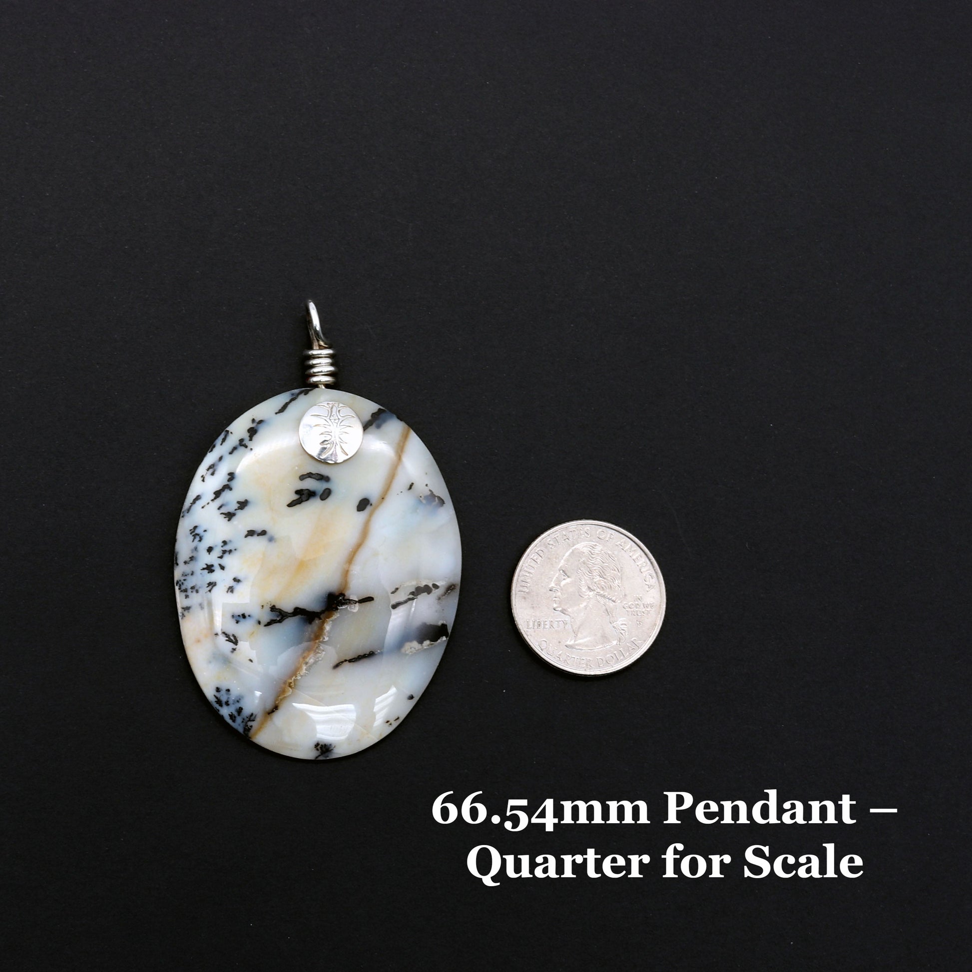 Handcrafted Dendritic Agate pendant with Argentium 935 Silver bail, 66.54mm, laid flat on a black background next to a U.S. quarter for size comparison.