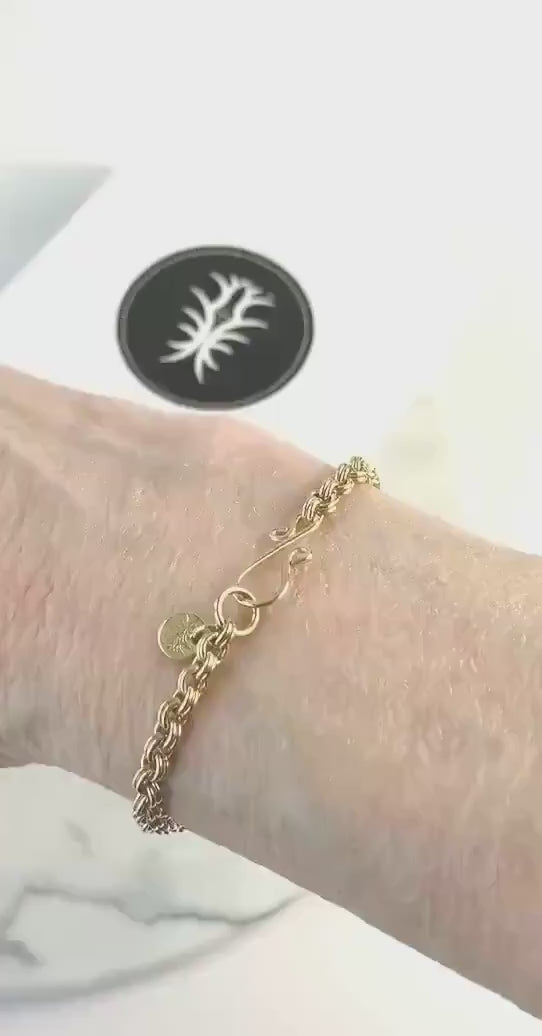 Demo of bracelet on wrist showcasing the shine of the brass used to make this double-link bracelet with shook clasp.