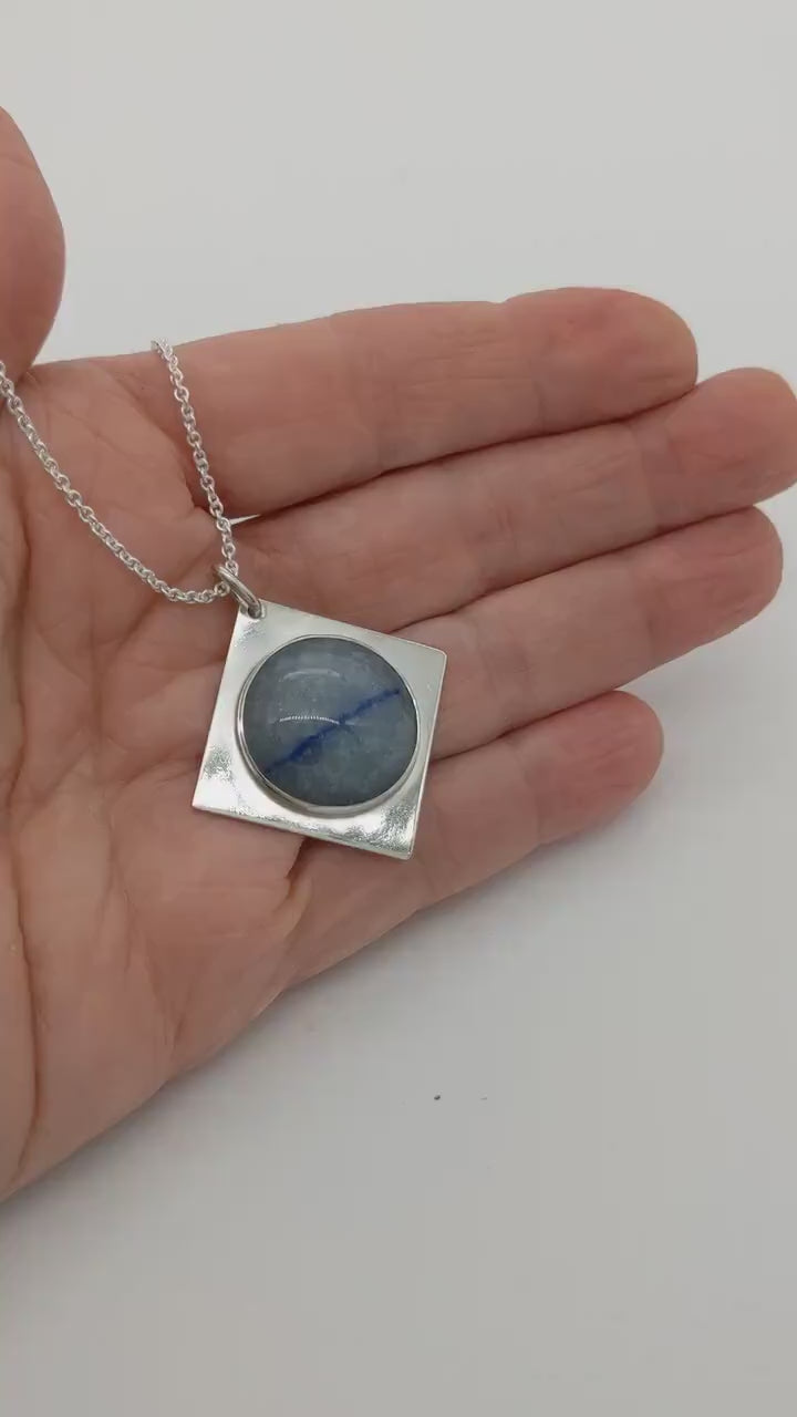 Video showing features of the Celestial Blue Aventurine pendant with Saturn-like inclusions in a models hand.