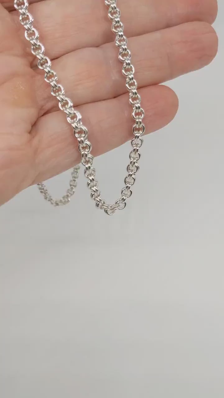 Demonstration of necklace design in a human hand.