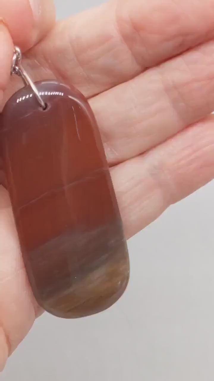 See the Glow: This short video shows the pendant illuminated from behind with a flashlight, revealing the natural translucence and warm internal glow of Petrified Rainbow Wood. Demo of Tag-Shaped Petrified Rainbow Wood Pendant – Handcrafted Focal Piece for Jewelry Making, Fossilized woodHandcrafted in USA, 2.67"