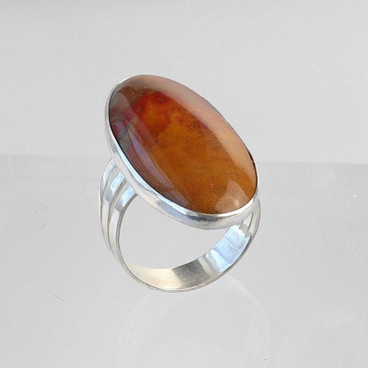 This Sonoran Sunrise gemstone ring features a striking blend of Chrysocolla and Cuprite—known for their vivid red, green, and turquoise hues. The handcut cabochon has been expertly shaped and polished and set in a band of Argentium® 935 Silver.