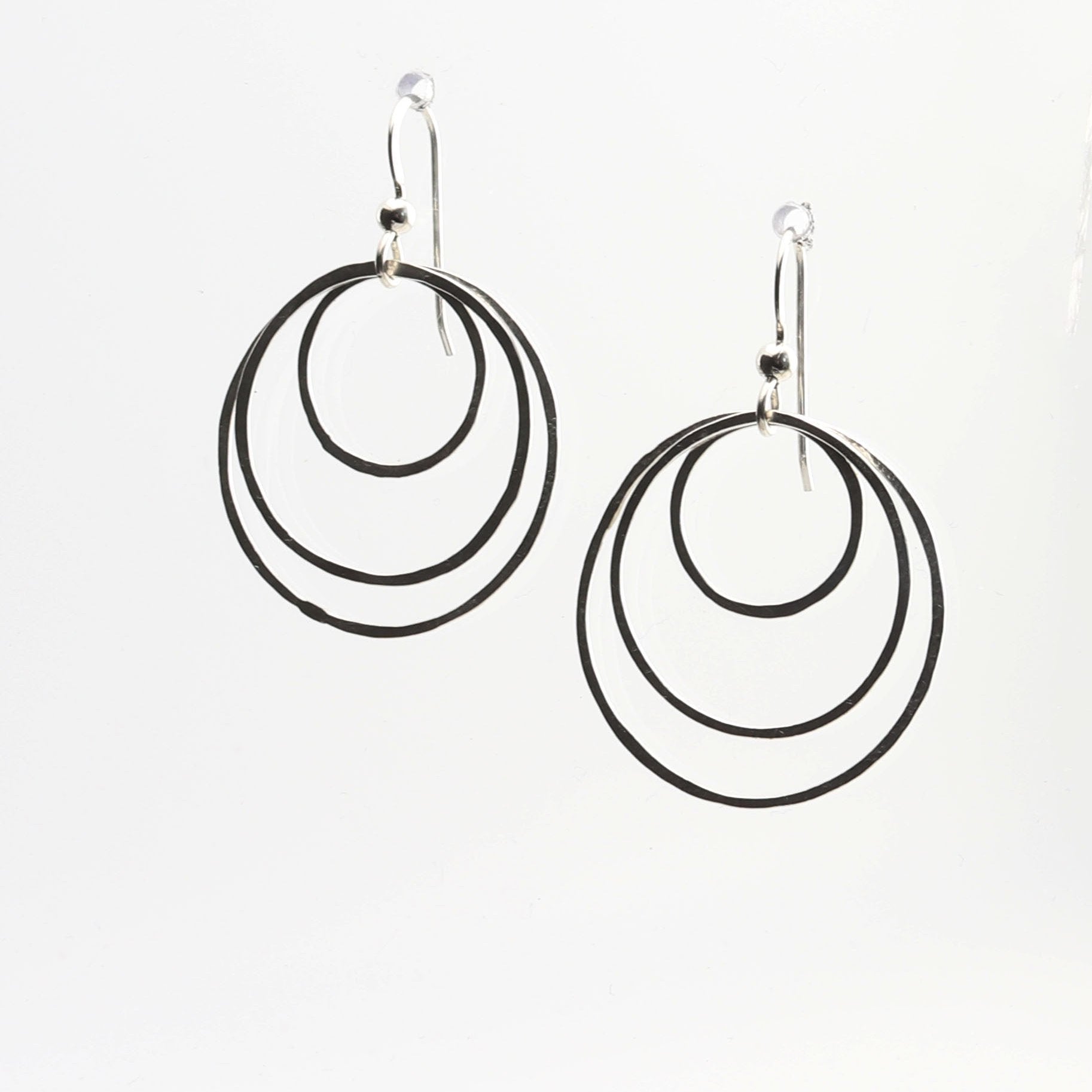 Discover the perfect blend of sustainability and style with our handcrafted hammered hoop earrings. Made from 100% recycled Argentium® 935 silver, these tarnish-resistant earrings are designed to last while maintaining their brilliant finish.