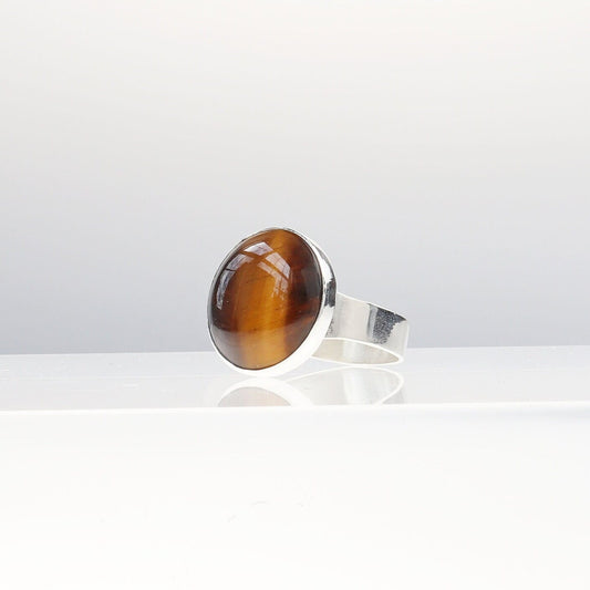 Tiger’s Eye ring in Argentium® 935 Silver, size 11.75. Features round handcut cabochon with golden chatoyancy.