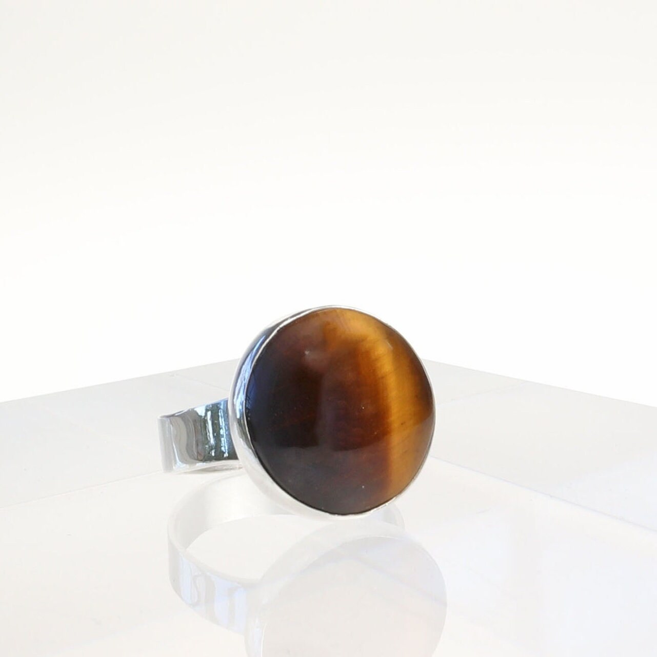 Side angle profile of Tiger’s Eye gemstone ring with fine silver bezel setting.