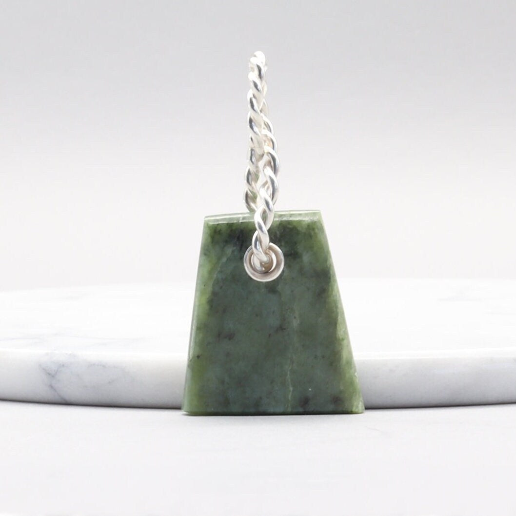 Handcrafted in our Missouri USA studio is this one-of-a-kind reversible trapezoidal shaped Wyoming Jade pendant with a twisted sterling Argentium 935 bail.