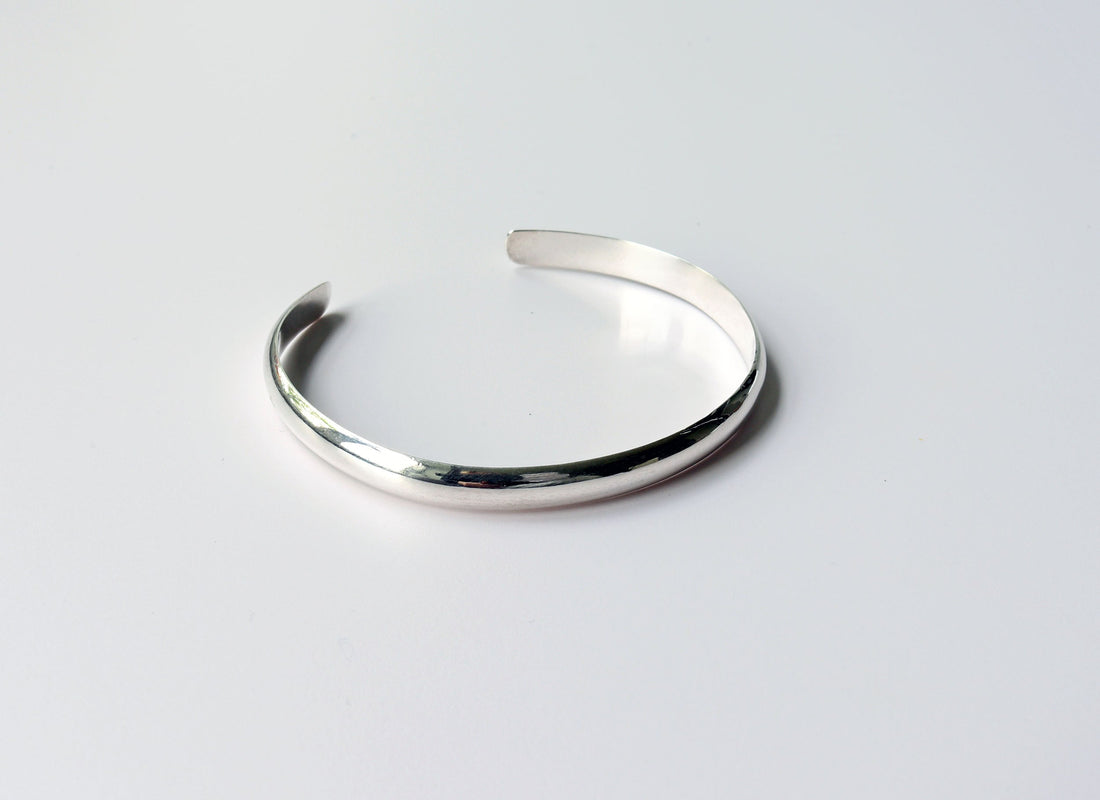 A Silver Cuff bracelet handcrafted in solid Argentium® 935. The gently curved low dome profile gives this cuff its sleek, modern look, while the open design allows for slight adjustability.