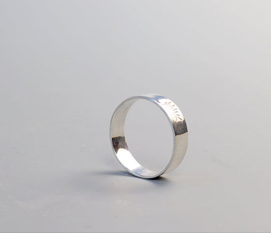 Handcrafted solid Argentium 935 silver narrow band ring with flat polished profile and softly finished edges, size 7.75.