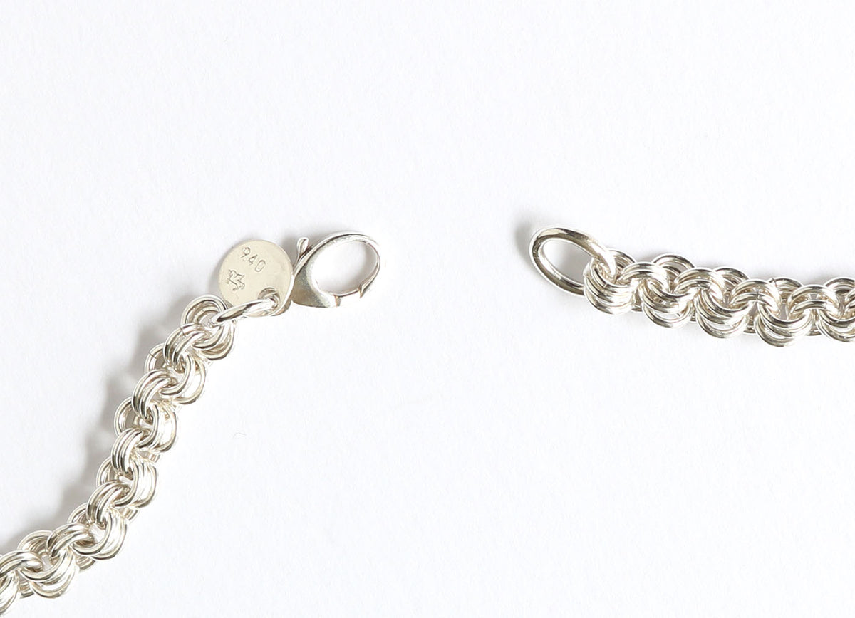 A close-up of a handcrafted solid Argentium Silver 4.5mm 3+2 cable chain necklace on a white background