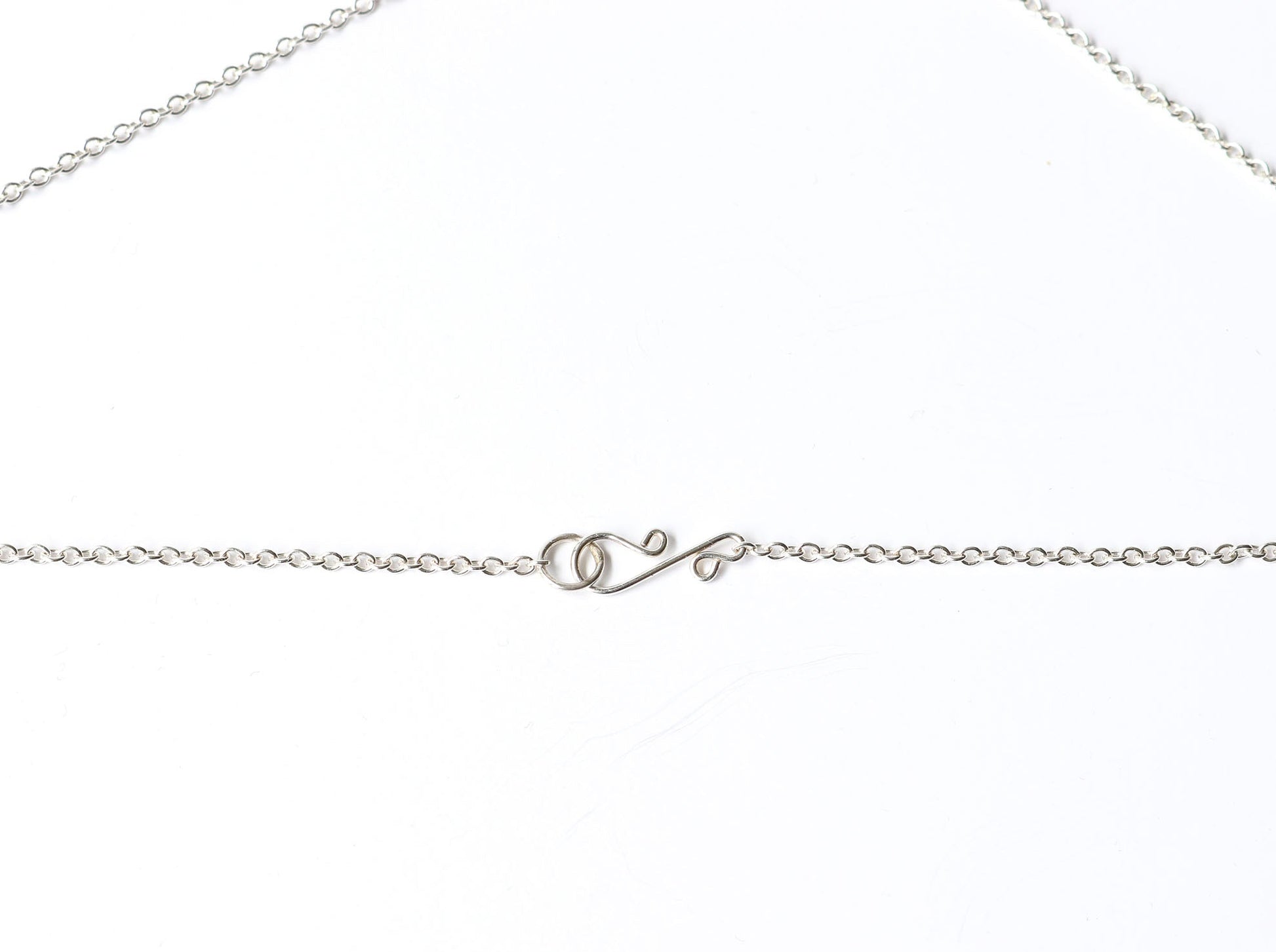 Closeup of s-hook clasp and 1.7mm necklace in Argentium Silver.