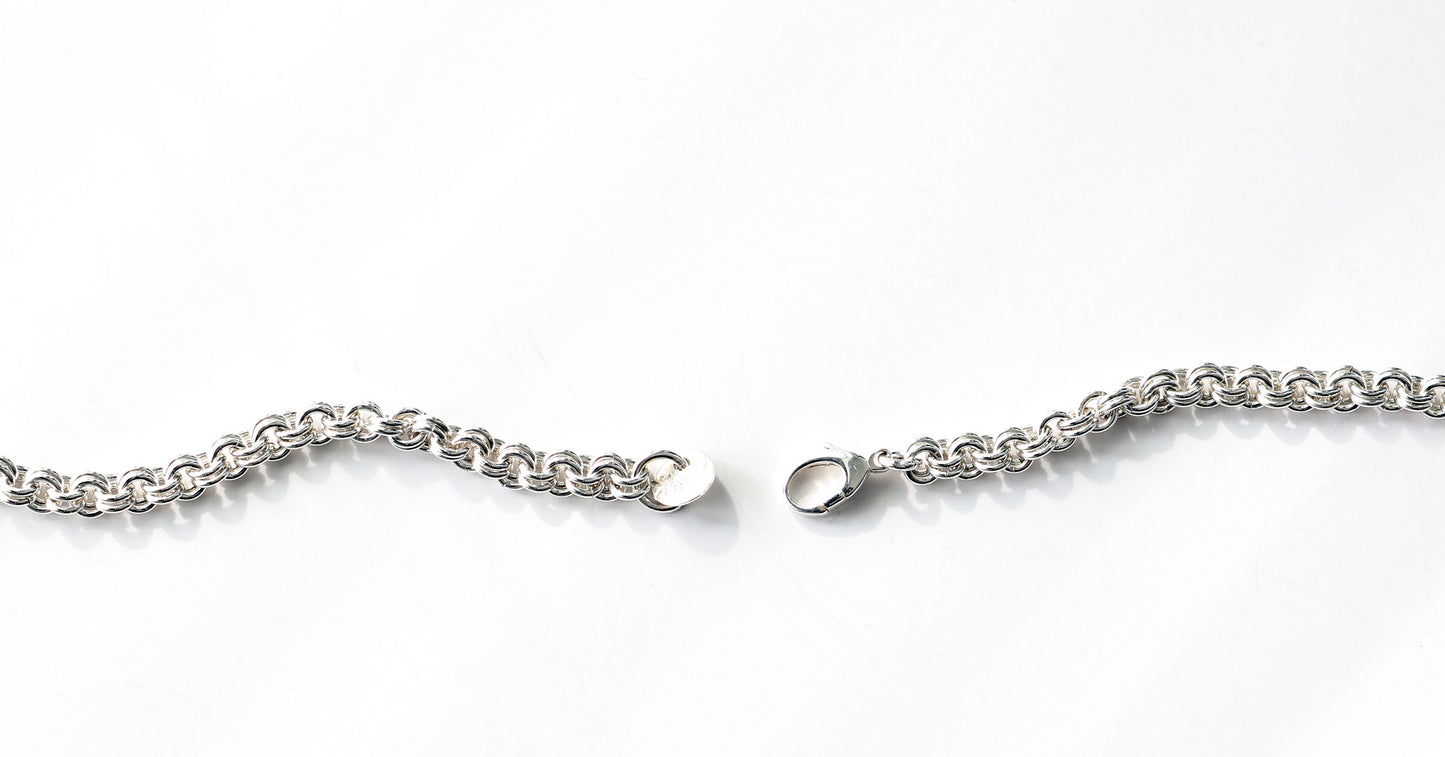 Double Cable Weave in Argentium Silver with sterling silver teardrop lobster clasp on a white background