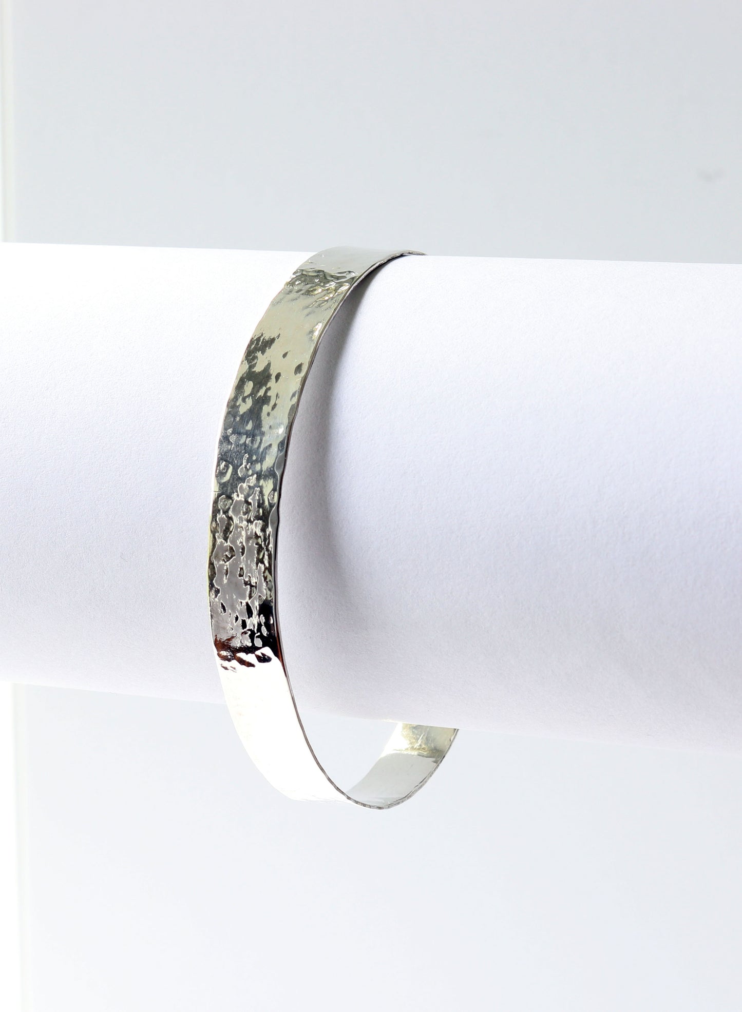 Argentium Silver bracelet on a white stand with a white background
