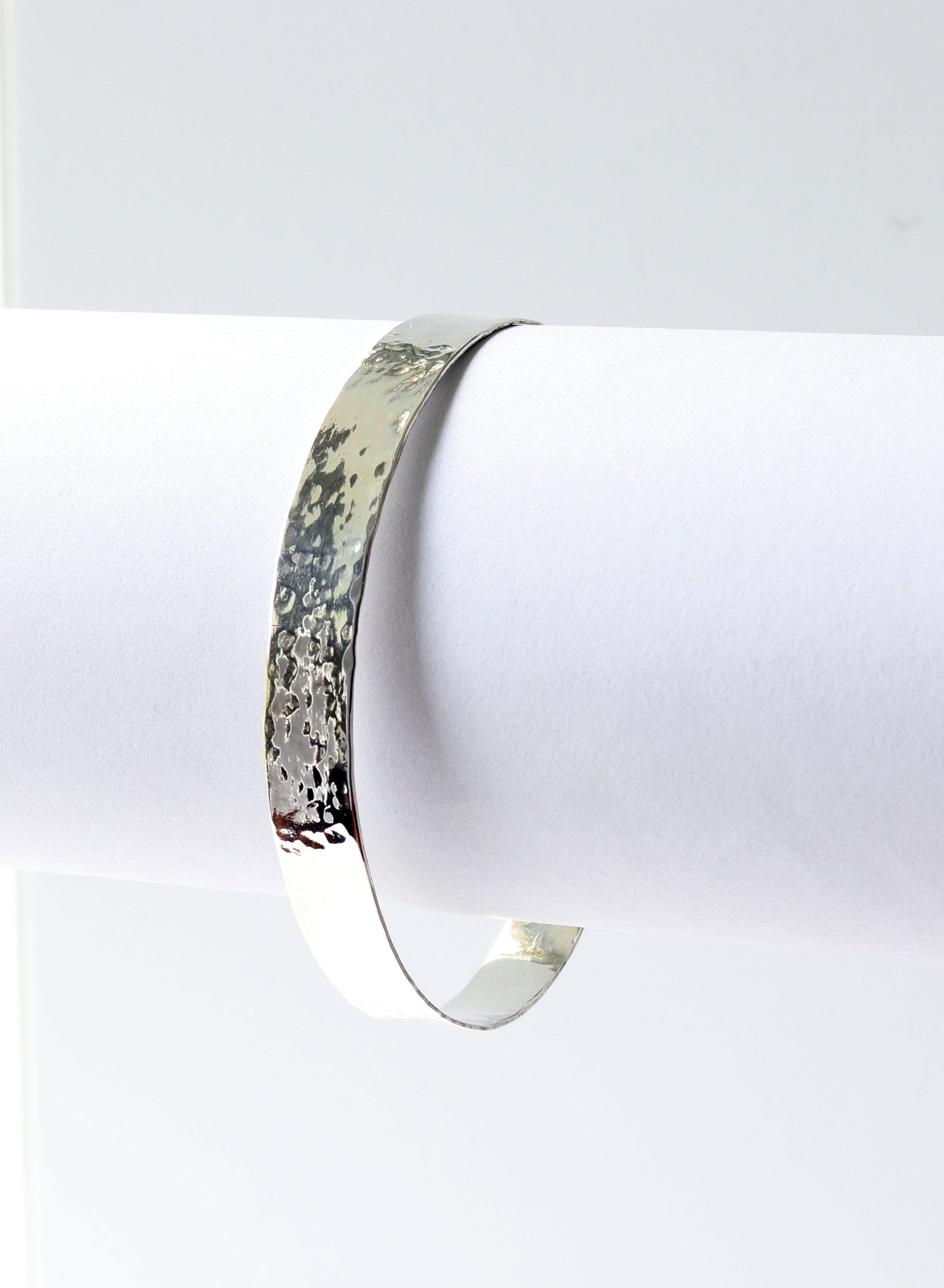 Argentium Silver bracelet on a white stand with a white background