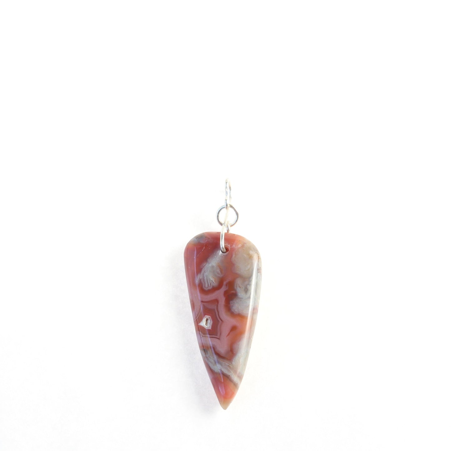 A Crazy Lace Agate arrow shaped gemstone pendant. 
Handcut and freeform polished on both sides to reveal the unique swirling patterns and vibrant mauve deep reds and gray hues. 