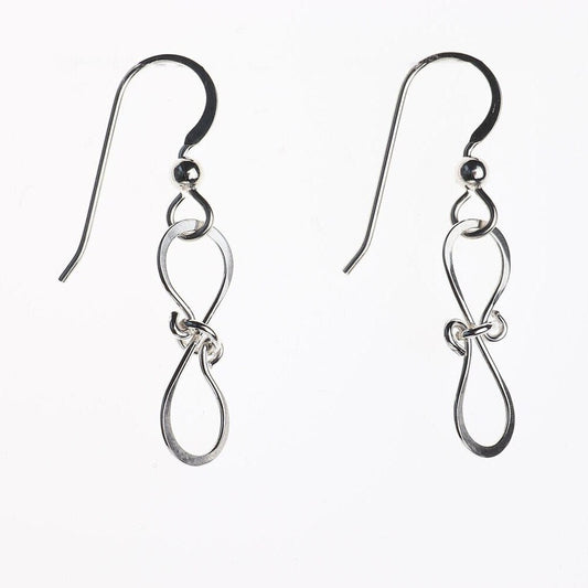 Solid Argentium 935 silver bow drop earrings handcrafted with linked bow-shaped loops shown against white background.