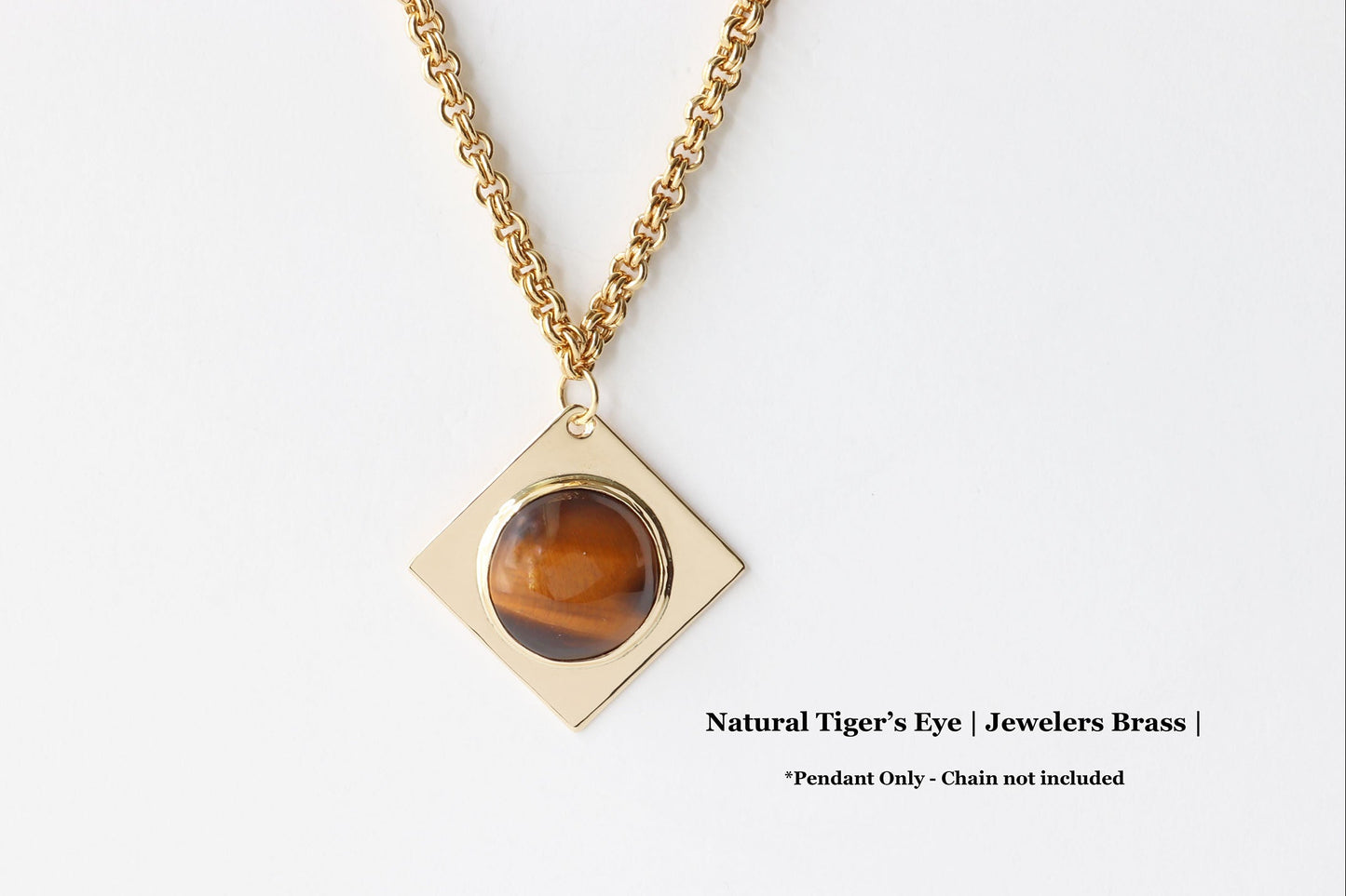 Jewelers Brass with a tiger's eye pendant on a white background. Pendant Only Chain not included.