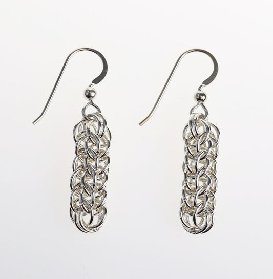 Our handcrafted solid silver dangle earrings, showcase a mesmerizing full Persian weave pattern, featuring interlocking links that create a captivating visual effect in premium sterling 935 Argentium® silver. The 935 Argentium® Silver ear wires, add a touch of elegance, ensure a comfortable and secure fit and are hypoallergenic.  Shown on white background.
