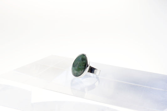 A Wyoming Jade Gemstone Ring.  Handcut and polished to showcase its unique translucent qualities, green hues and striking patterns. Encased in sterling hypo allergenic tarnish resistant 935 Argentium silver with a fine silver bezel.