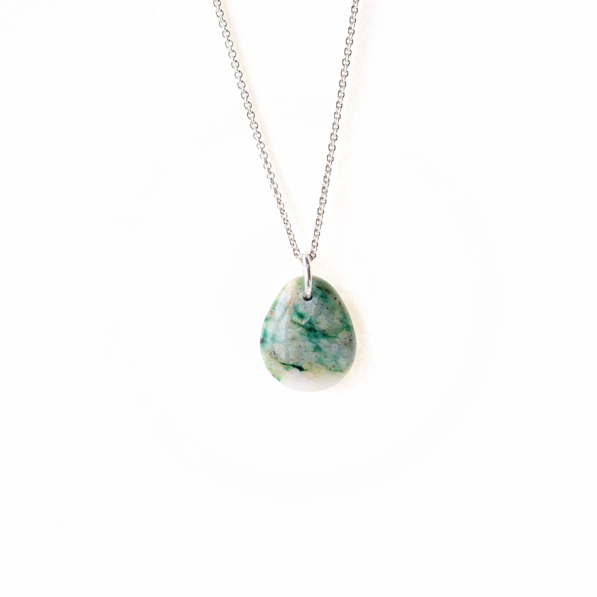 A stunning Mariposite gemstone pendant, handcrafted in Missouri, USA. This unique piece features a teardrop shape, handcut and polished on both sides to showcase the natural green and white hues of the Mariposite stone. The pendant is complemented by a custom 940 Argentium silver bail, adding a touch of sophistication to the design. To make this piece ready to wear, a matching 1.7 Argentium silver chain is optional + gift box.