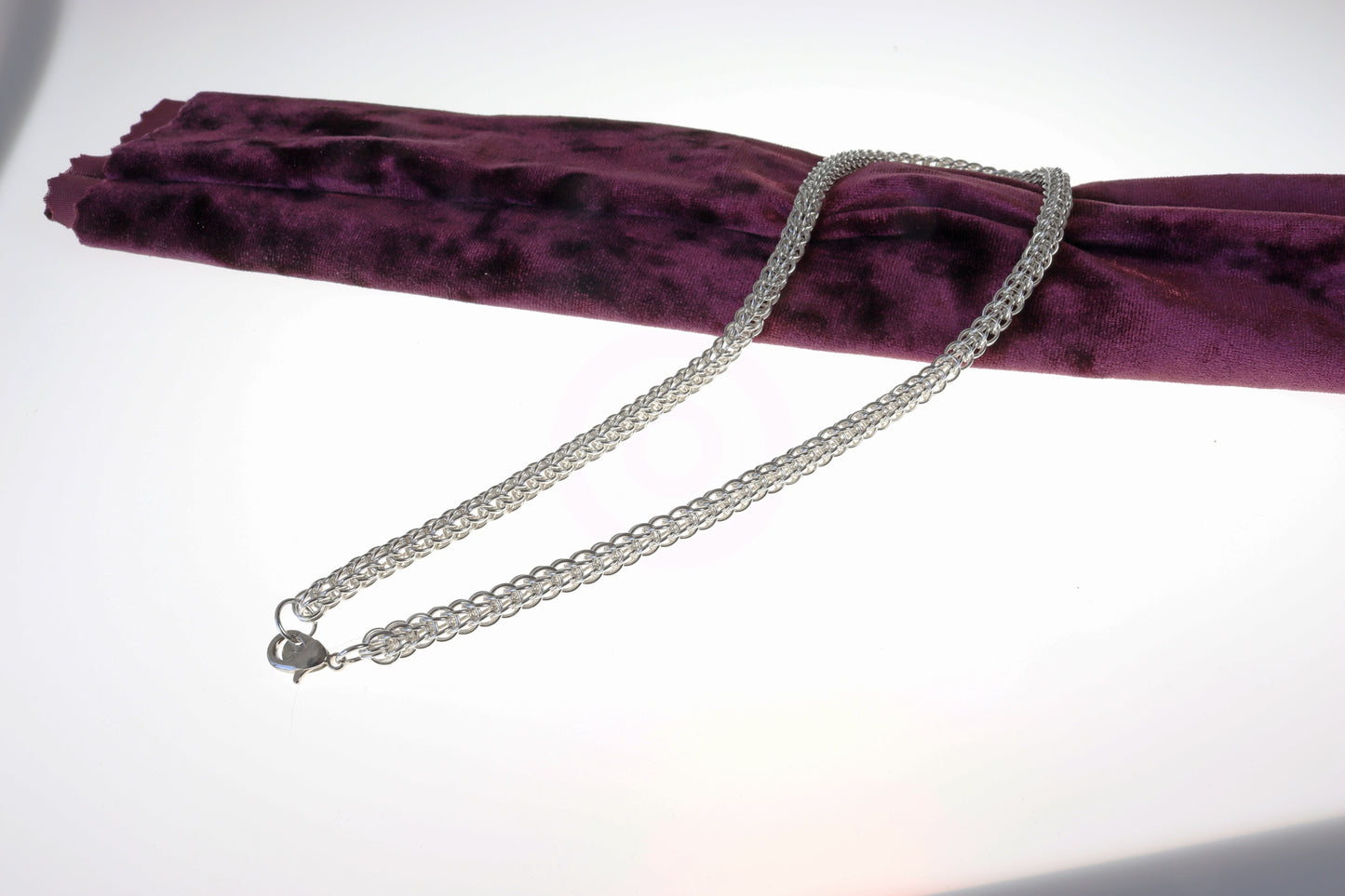 A Full Persian Weave necklace, a masterpiece of timeless craftsmanship. Handcrafted from over 400 precision-cut rings of premium 935 Argentium® Silver, this necklace offers exceptional tarnish resistance and hypoallergenic properties, making it a superior choice for both durability and everyday elegance.