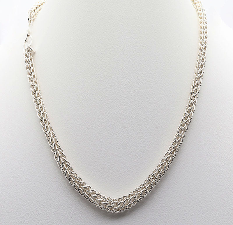 A Full Persian Weave necklace, a masterpiece of timeless craftsmanship. Handcrafted from over 400 precision-cut rings of premium 935 Argentium® Silver, this necklace offers exceptional tarnish resistance and hypoallergenic properties, making it a superior choice for both durability and everyday elegance.