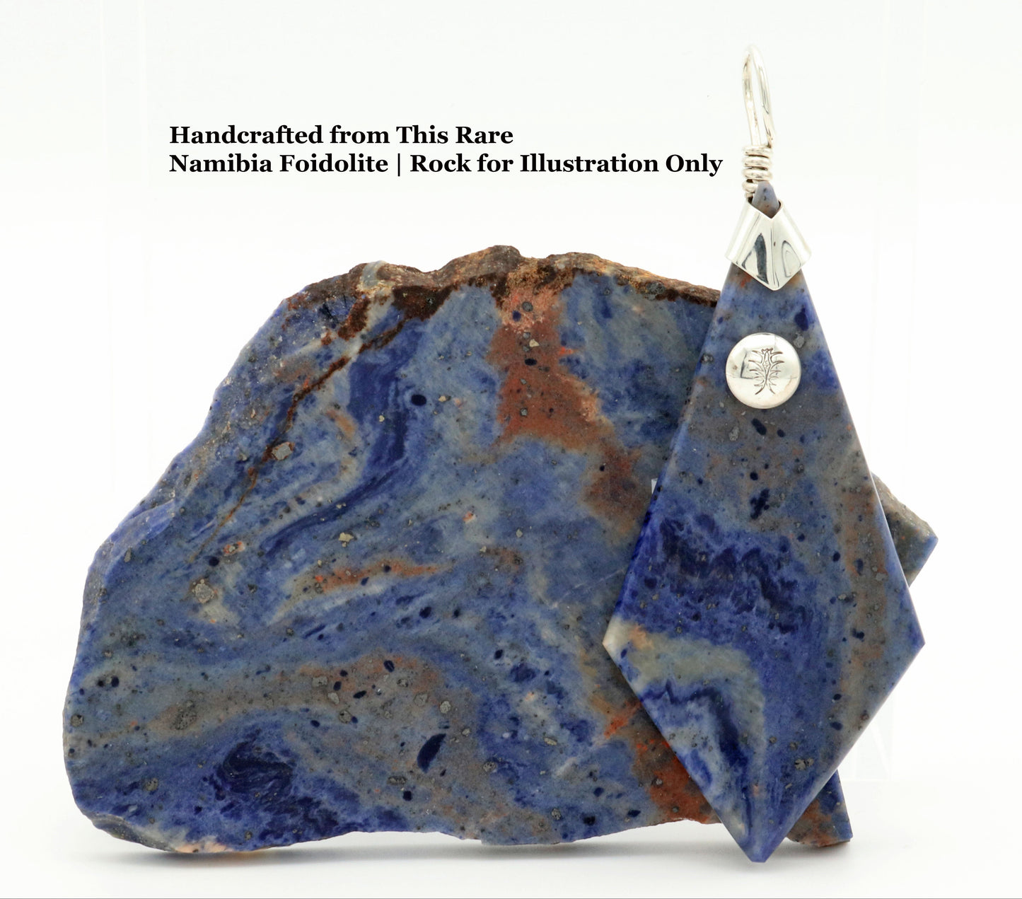 One-of-a-kind Namibia Foidolite pendant with Argentium 935 Silver bail, next to a raw Blue Foidolite rock (for illustration only) on white background.