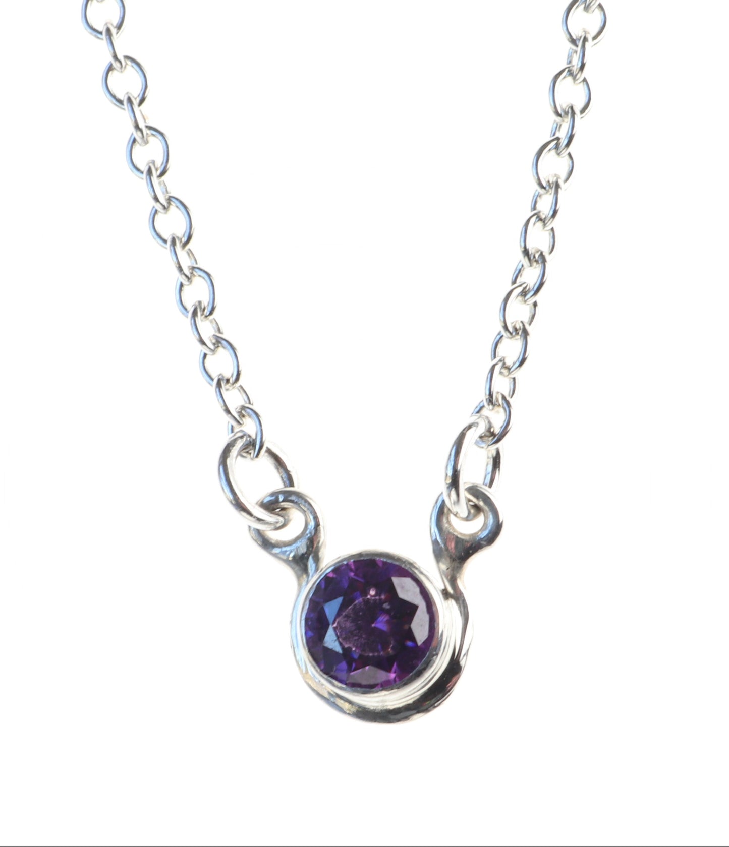 6mm Purple Cubic zirconia, set in Argentium 935 Silver, with delicate silver 1.9mm oval chains attached to either side shown on white background.
