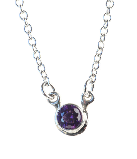 6mm Purple Cubic zirconia, set in Argentium 935 Silver, with delicate silver 1.9mm oval chains attached to either side shown on white background.
