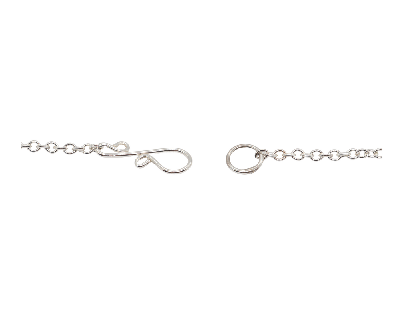 Closeup of s-hook clasp in Argentium Silver on white background.