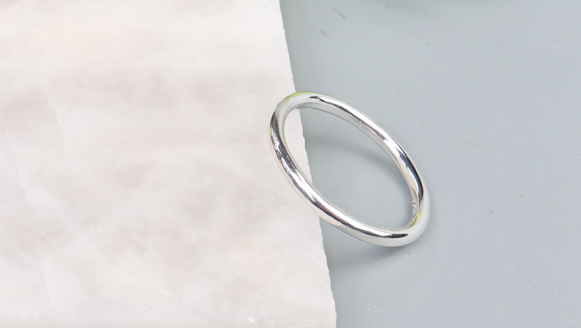 Silver ring on a light gray background
