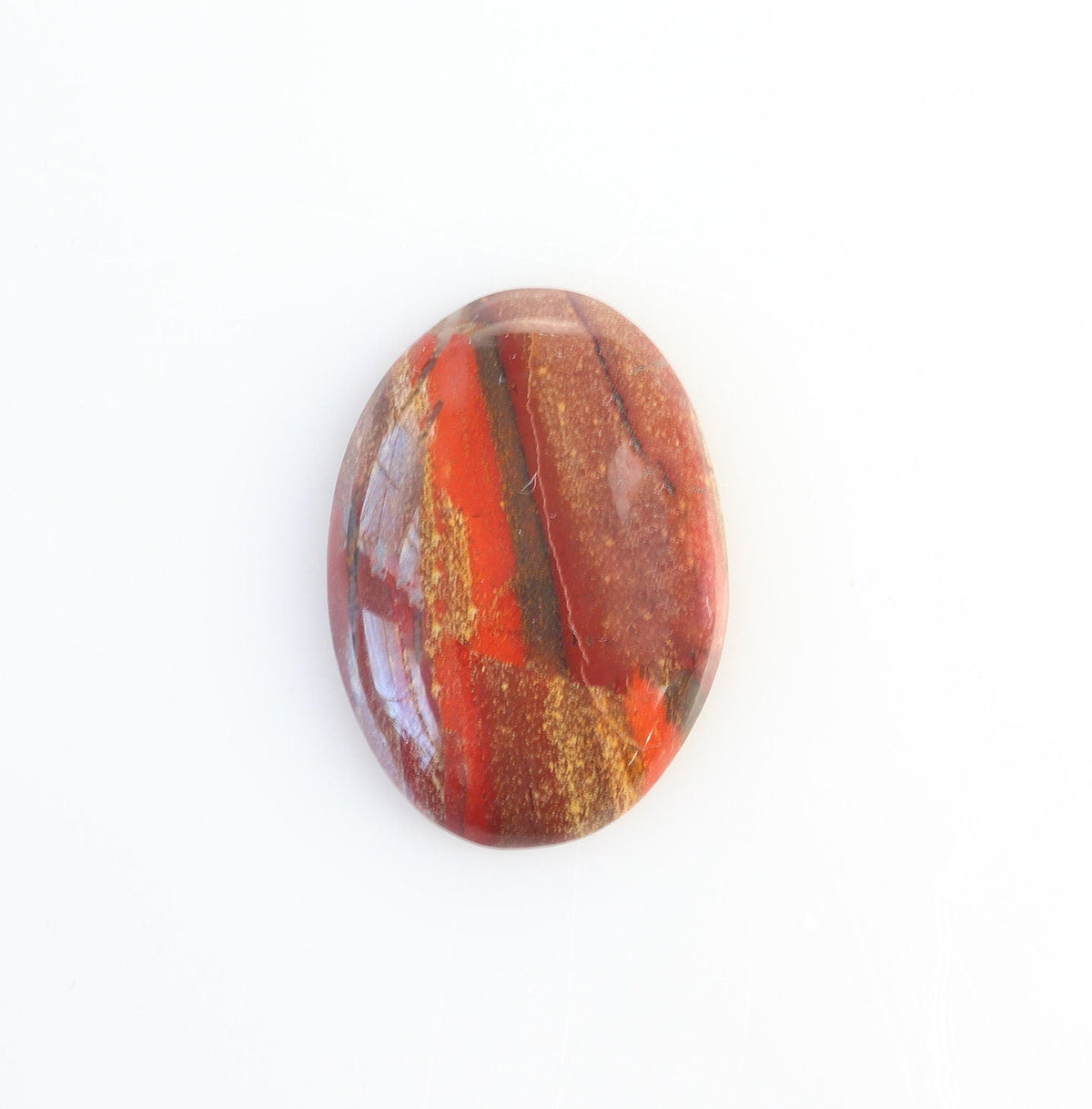 A handcut and polished to reveal the rich red and rust tones, accented by earthy brown, golden cream, and subtle gray features of this Snakeskin Jasper Cabochon shown on white background.