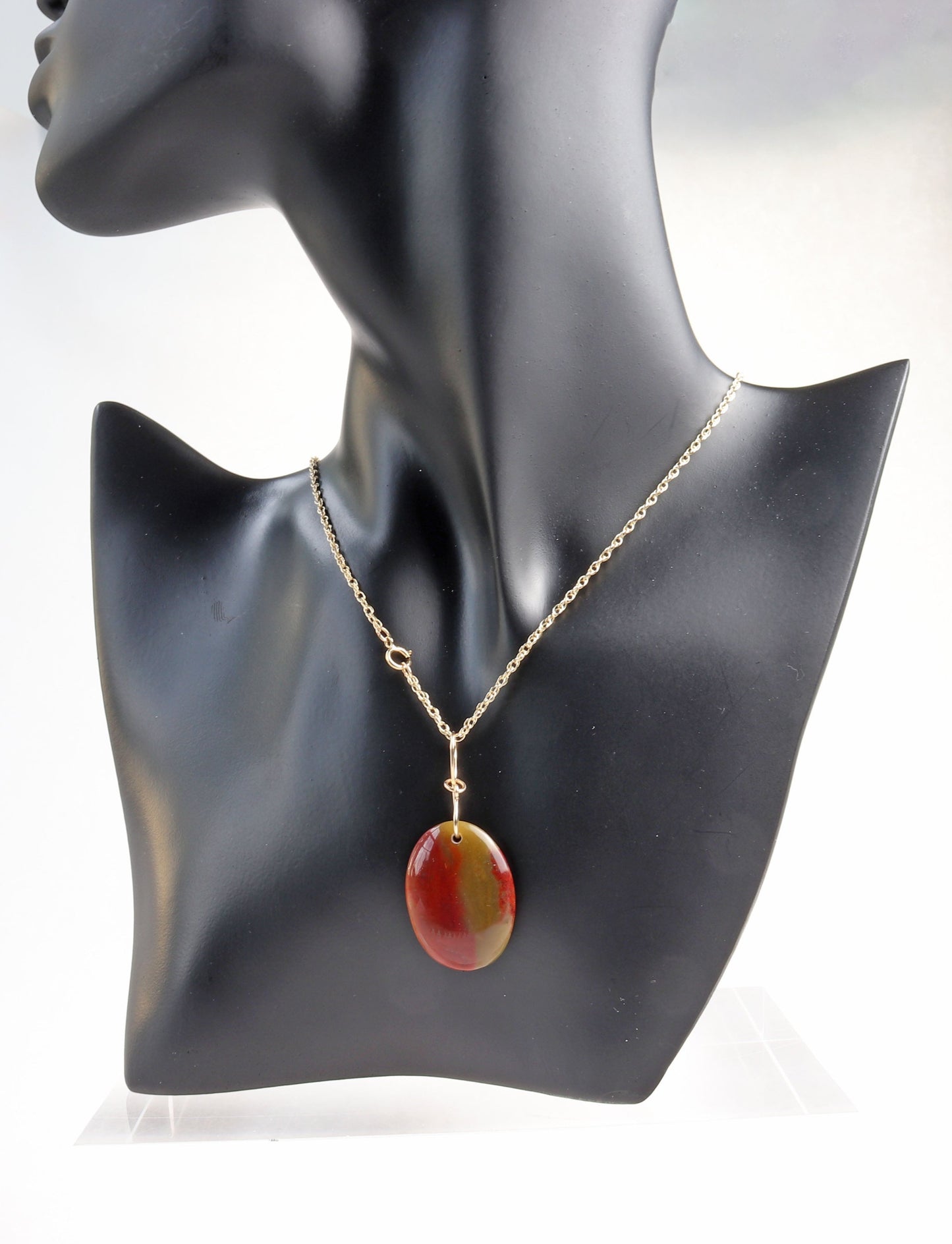 A natural Sonoran Sunrise Gemstone pendant, meticulously handcut and polished in our Missouri studio. The bespoke 14/20 Gold Filled wire infinity bow-shaped bail adds a unique touch. Versatile and chic, use it as an eye-catching centerpiece for your next jewelry design or pair it with your favorite chain to complete the look.