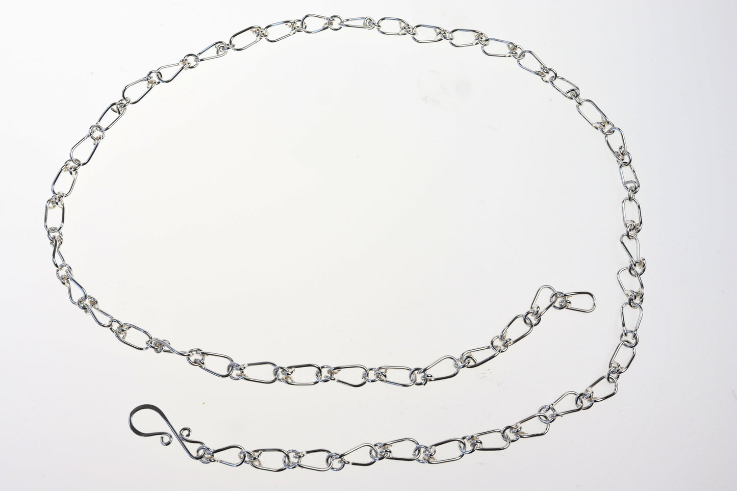 A Teardrop shape link necklace in Argentium Silver shown on white background.