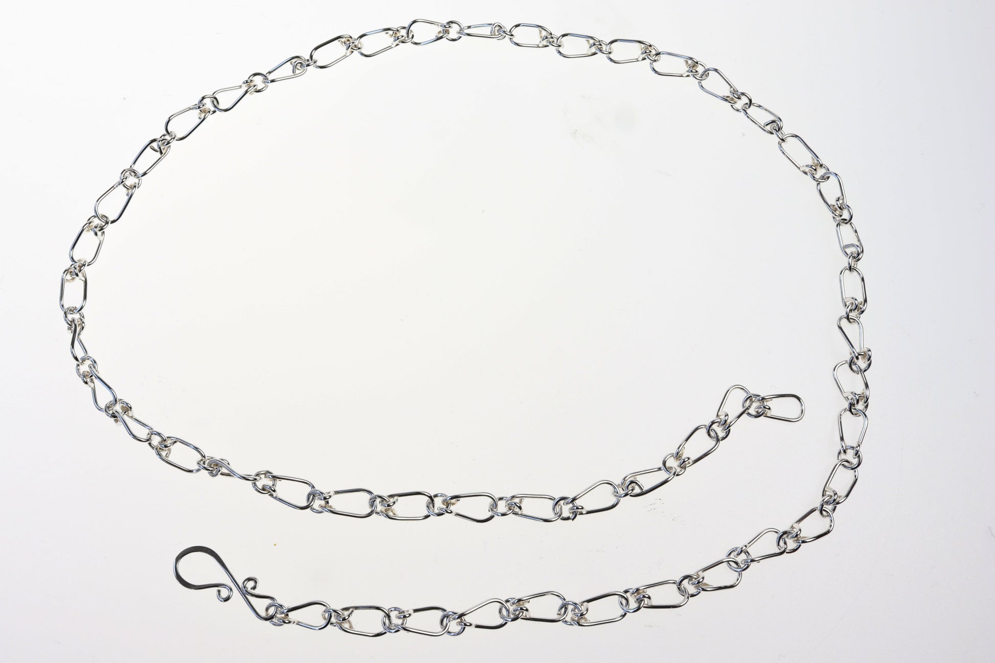 A Teardrop shape link necklace in Argentium Silver shown on white background.