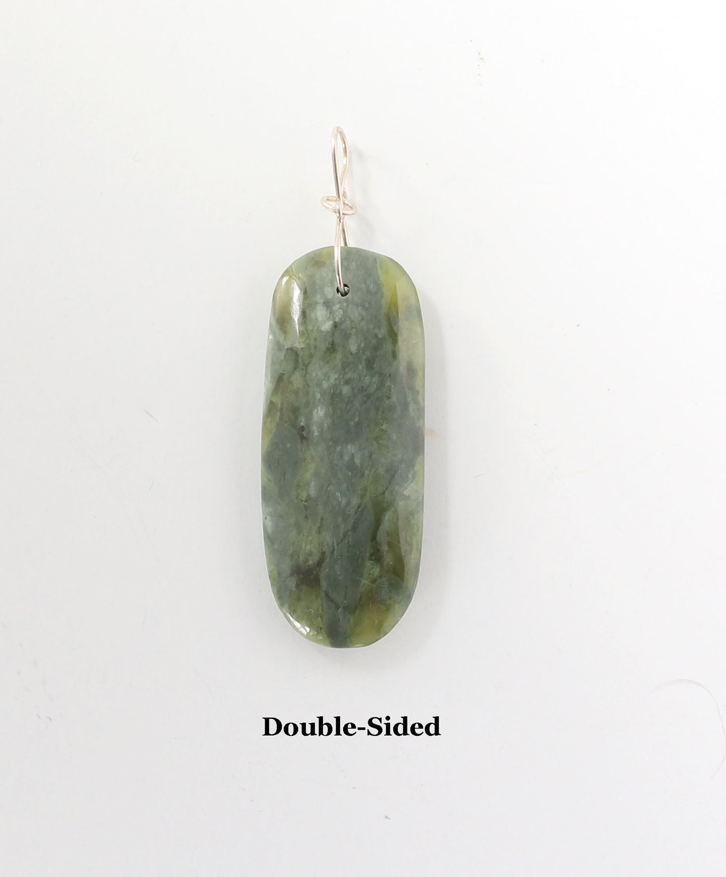 A double-sided polished green jade pendant with a silver wire loop at the top, shown against a plain white background with the text 'Double-Sided' underneath.