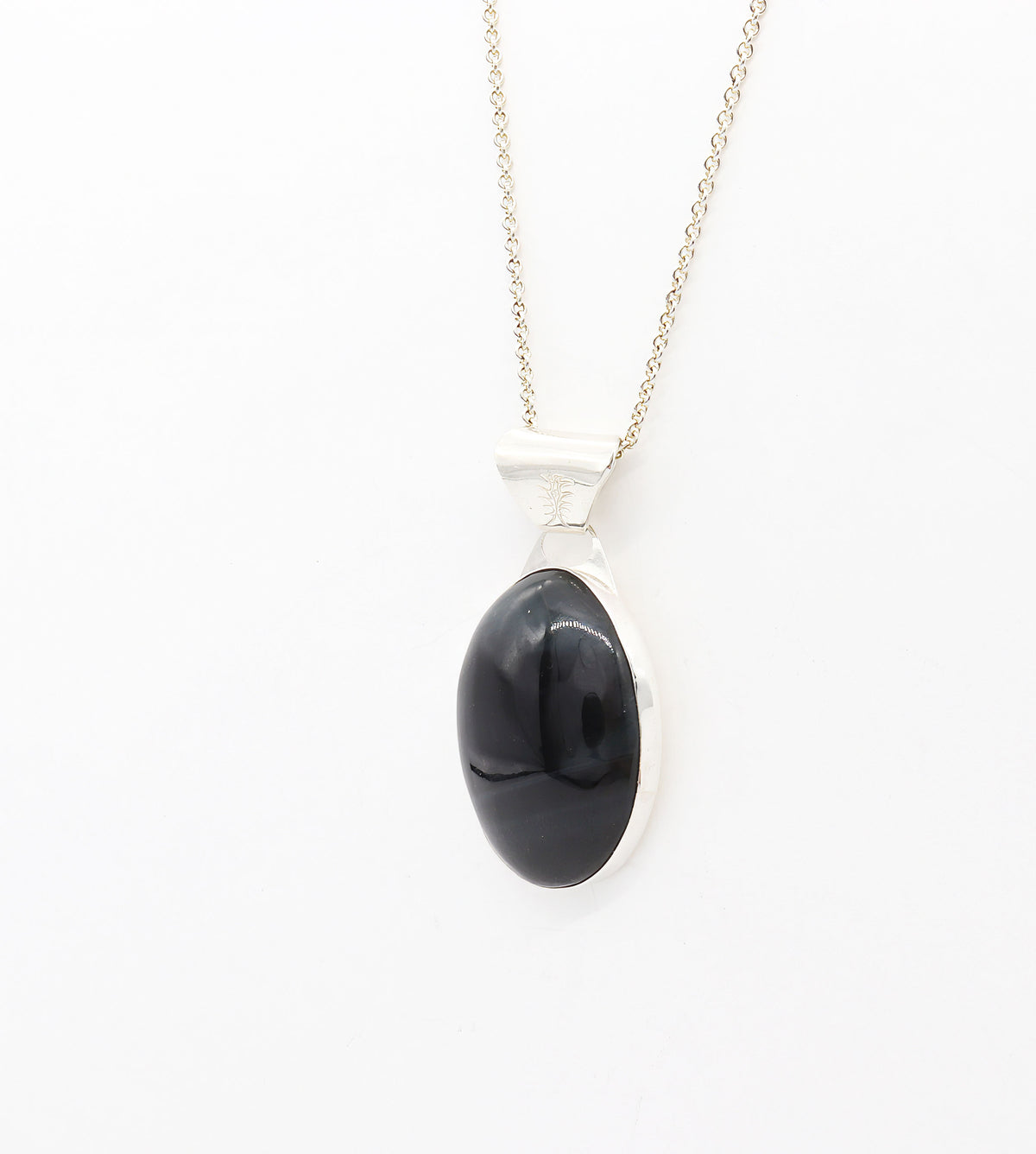 Oval natural Blue Tiger’s Eye pendant in a polished Argentium 935 silver bezel, suspended from a silver chain against a white background.