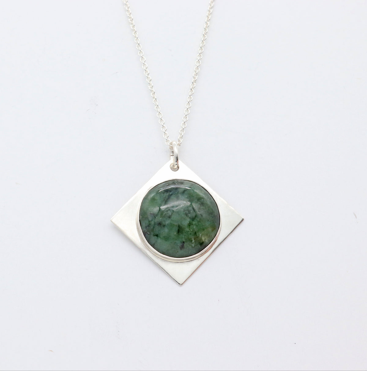 Star-shaped Wyoming Jade pendant set in solid Argentium silver with 1.7 Argentium chain against a white background