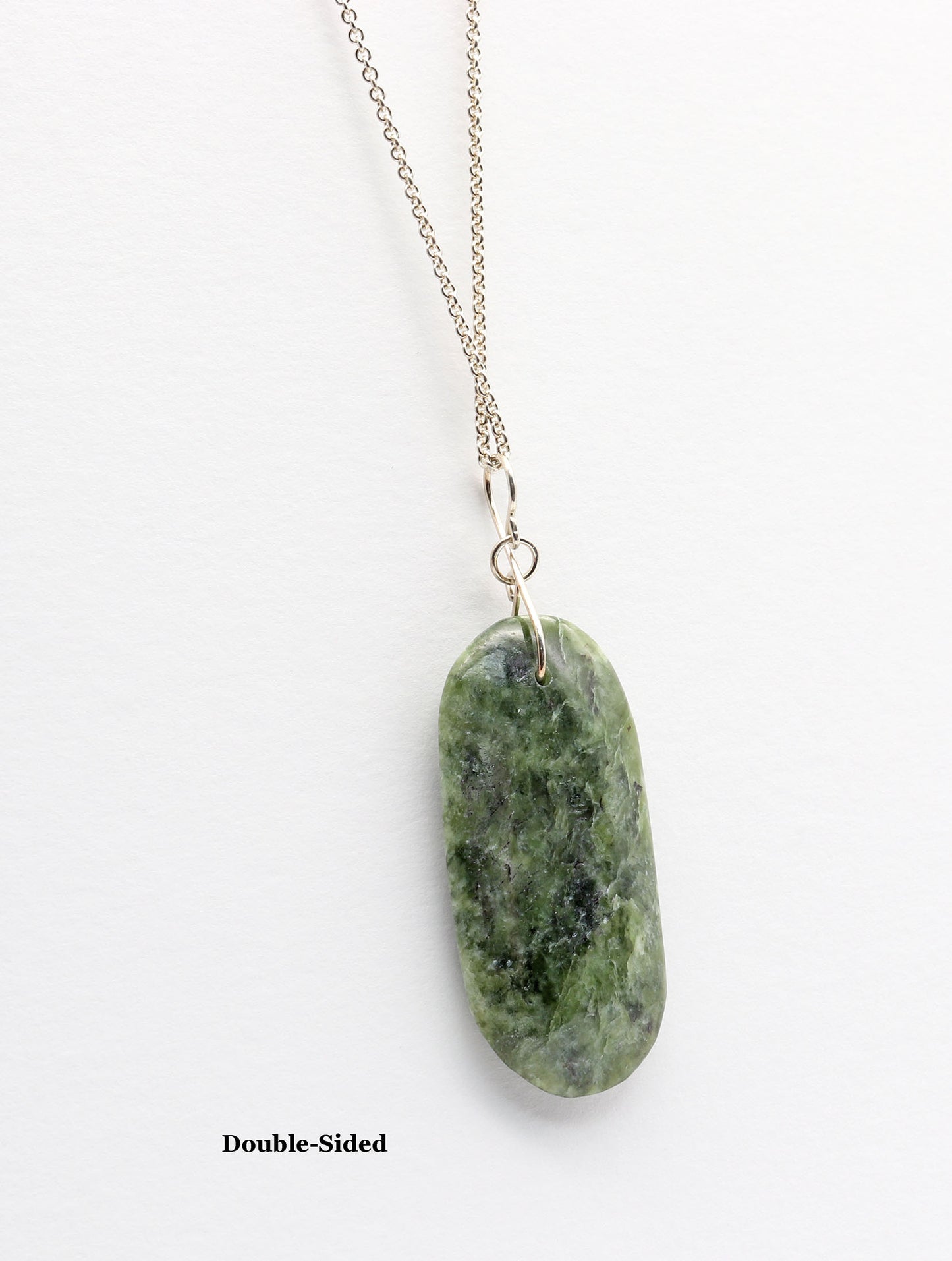 A double-sided green Wyoming Jade stone pendant necklace on a delicate silver chain, shown against a plain white background with the text 'Double-Sided' printed below.