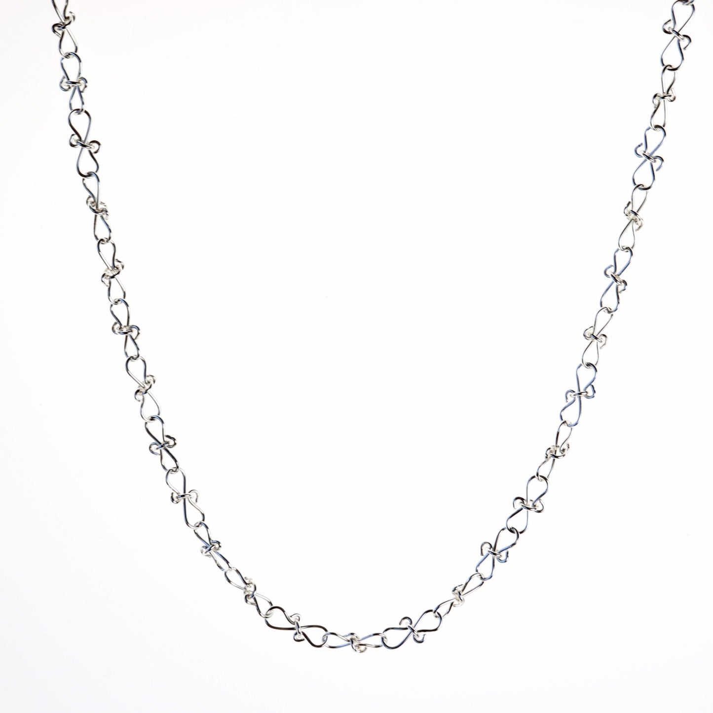 Adjustable Infinity bow shaped 18" Necklace.  Handcrafted in our Missouri studio, using solid 20 Gauge sterling 935 Argentium silver to create a piece that displays elegance and quality. 