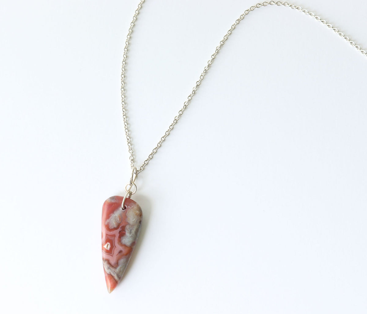 Crazy Lace Agate teardrop necklace with handcrafted Argentium Silver oval-link chain displayed on a clean white background.