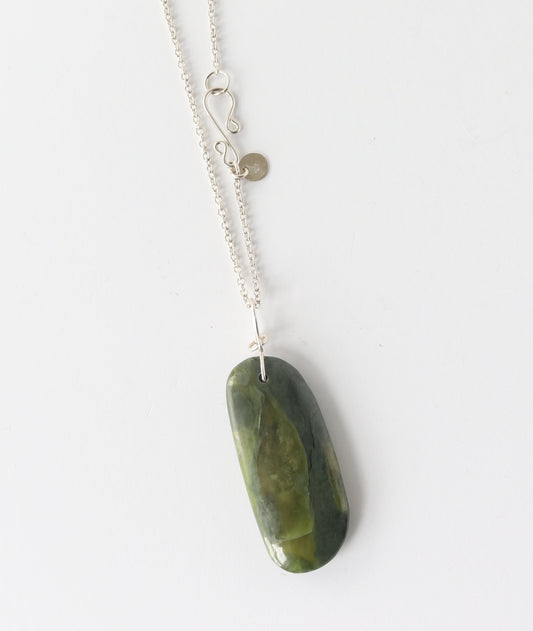 A silver chain necklace with a polished California jade stone pendant, photographed against a plain white background.