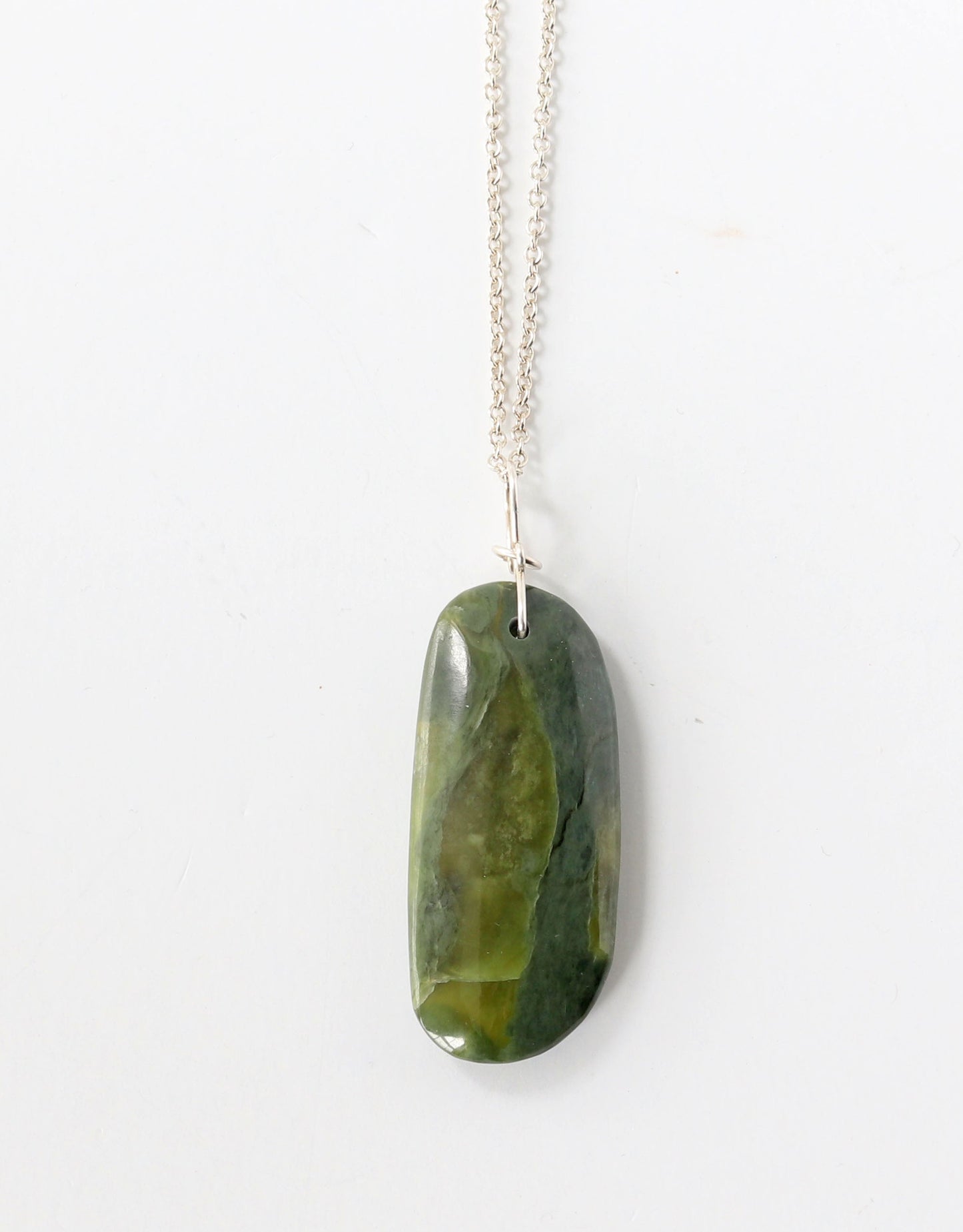 Green stone pendant on a optional Argentium silver chain against a white background