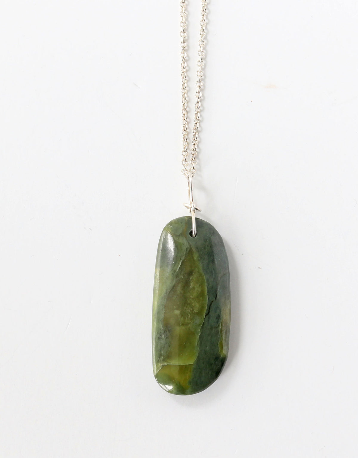 Green stone pendant on a optional Argentium silver chain against a white background