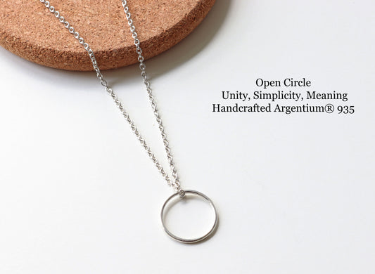 Argentium 935 Silver open circle necklace on a white background with cork base
