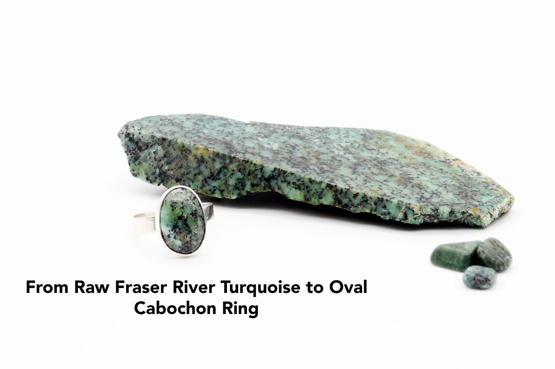 Raw Fraser River turquoise stone used to craft the oval cabochon ring on a white background.