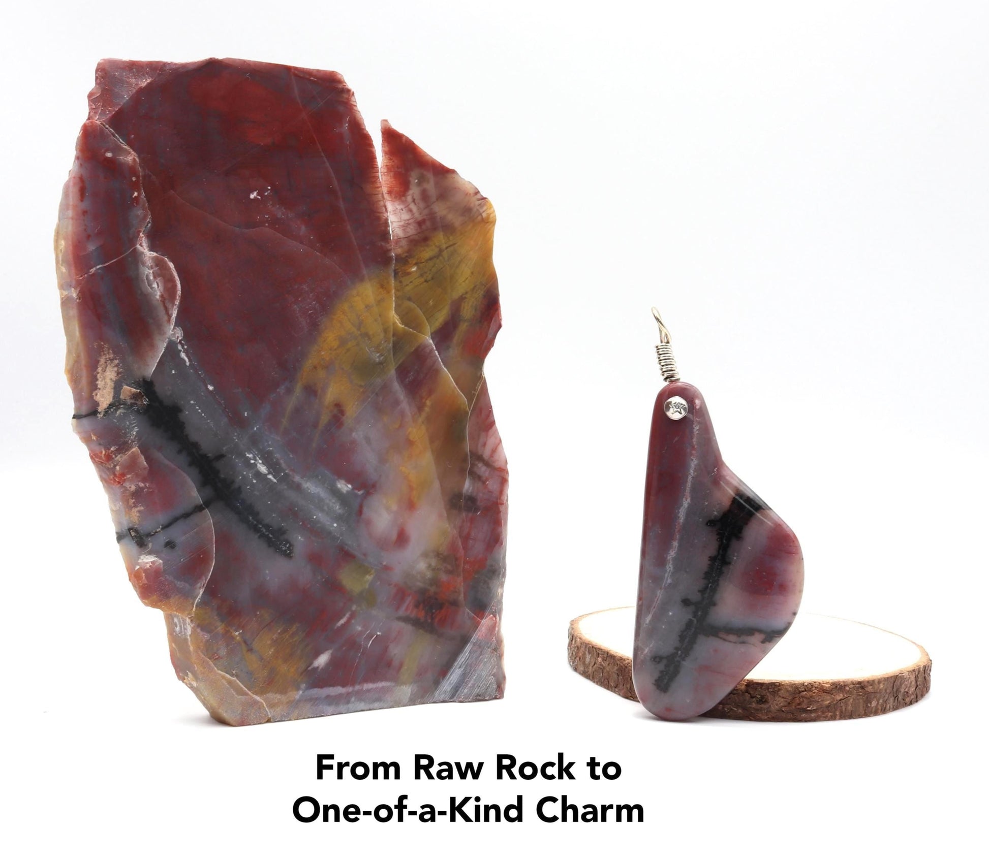 Handcrafted Arizona Petrified Rainbow Wood charm, 4 inches long, with a 935 silver bail, on a white background, next to the raw Petrified Rainbow Wood rock used to craft it, showcasing the transformation from raw rock to a one-of-a-kind gemstone with bold red and carbon black stripes and natural swirls.